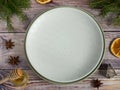 Empty plate, silverware and christmas tree. View from above over wooden table background Royalty Free Stock Photo