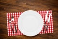 Empty plate and silverware on wooden table. Top view with copy space Royalty Free Stock Photo