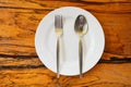 Empty plate with spoon fork on food table wooden background - empty dinner plate dish , top view Royalty Free Stock Photo