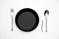 Empty plate spoon fork knife on white Royalty Free Stock Photo