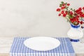 Empty plate on tablecloth or napkin on wooden table over cement background Royalty Free Stock Photo