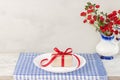 Empty plate on tablecloth or napkin on wooden table over cement background Royalty Free Stock Photo