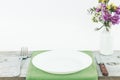 Empty plate on tablecloth on wooden table over grunge blue Royalty Free Stock Photo