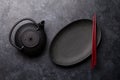 Empty plate, teapot and chopsticks Royalty Free Stock Photo