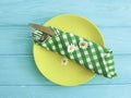 Empty plate of a towel rustic on a blue wooden background daisy flower fork, knife Royalty Free Stock Photo