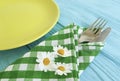 Empty plate of a towel rustic summer on a blue wooden background daisy flower fork, knife Royalty Free Stock Photo