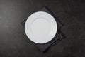 Empty plate and towel on stone kitchen table. Flat lay with copy space Royalty Free Stock Photo
