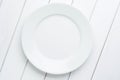 Empty plate on white planked wooden background. Top view with copy space Royalty Free Stock Photo