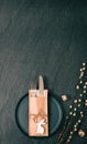 Empty plates with a knife, fork and Easter decorations on a black background.