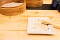 Empty plates and wooden steamer from steamed dumplings on a wooden table with chopsticks in an asian restaurant or chinese bar