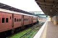 Empty platform of a railway station in Sri Lanka. Old rusty train cars. It looks like an abandoned place, but it not Royalty Free Stock Photo