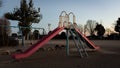 An empty playground with equipment slide, swings, and tires at an elementary school in Saitama, Japan Royalty Free Stock Photo