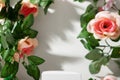 Empty podium and border of artificial flowers with leaves Royalty Free Stock Photo
