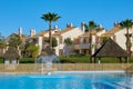 An empty pool with a fountain waiting for vacationers