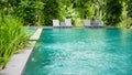 Empty poolside loungers with umbrellas Royalty Free Stock Photo