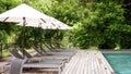 Empty poolside loungers with umbrellas Royalty Free Stock Photo