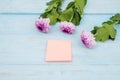 Empty post it paper with pink gerbera flower