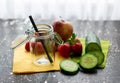 Preserving jar surrounded by fresh fruit and a cucumber Royalty Free Stock Photo