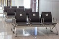 Empty priority public seats for disabled people. White sign with a handicap man in a wheelchair.