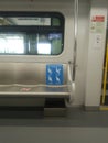 Empty priority train seat with social distancing sign