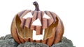 Empty pumpkin with a scary face engraved on it against a white background