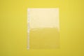 Empty punched pocket on yellow background, top view Royalty Free Stock Photo