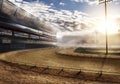 Empty race track near mountain with stadium lights Royalty Free Stock Photo