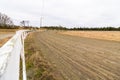 Empty race track for racing horses, sand track and white fence Royalty Free Stock Photo