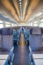 Empty rail passenger carriage seat rows with dimishing perspective Royalty Free Stock Photo