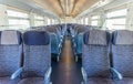 Empty rail passenger carriage seat rows with dimishing perspective Royalty Free Stock Photo