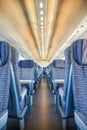 Empty rail passenger carriage seat rows with dimishing perspective Royalty Free Stock Photo