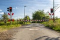 Empty railroad crossing in the countryside, on the road with open barriers. Royalty Free Stock Photo