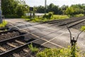 Empty railroad crossing in the countryside, on the road with open barriers. Royalty Free Stock Photo