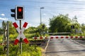 Empty railroad crossing in the countryside, on the road with open barriers. Royalty Free Stock Photo