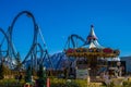 Empty railroad rails with carousel in amusement park with clear