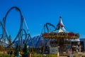 Empty railroad rails with carousel in amusement park with clear