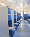 Empty railway carriage of electric train in white and blue colors, in the light of the bright sun Royalty Free Stock Photo