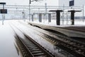 Empty railway and platform covered with snow