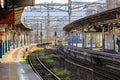 Empty railway station platform with double-track railroad railway or train tracks in suburb train station, perspective view. Royalty Free Stock Photo