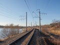Empty railway track, single rail. Railway track turns and twists between out of focus hills background. Empty rounding and turning