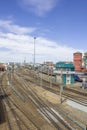 Empty railway tracks on the background of modern trains with cars, station buildings and the city Royalty Free Stock Photo