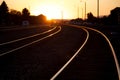Empty railways with the golden sunset shining brightly in the background Royalty Free Stock Photo