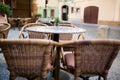 Empty rattan chairs and tables outside a street restaurant at the city Royalty Free Stock Photo