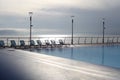 Empty Recreation area with pool and beach lounger near the sea. Evening nature calm landscape Royalty Free Stock Photo