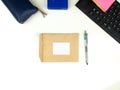 empty recycled paper stationery set mockup with white layout in the center and pen on the side, isolated against white office desk