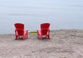 Empty red Adirondack chairs on the edge of a cliff Royalty Free Stock Photo