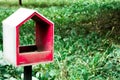 The empty red birdhouse in the green park. Save the natural environment. Sweet home Royalty Free Stock Photo