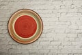 Empty red ceramic dish plate with spiral pattern on gray background. Top view with copy space. Royalty Free Stock Photo