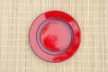 Empty red ceramic plate on table Royalty Free Stock Photo