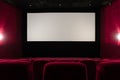 Empty red cinema hall. View of empty white cinema screen with red chairs Royalty Free Stock Photo